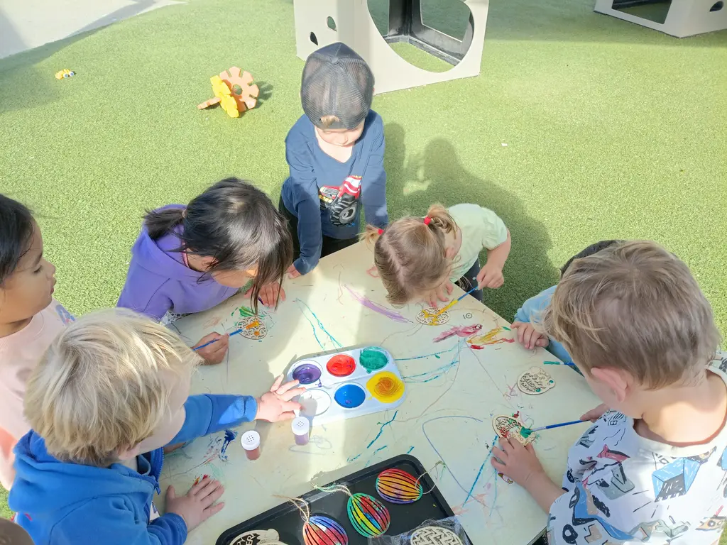 Tamariki painting together outside