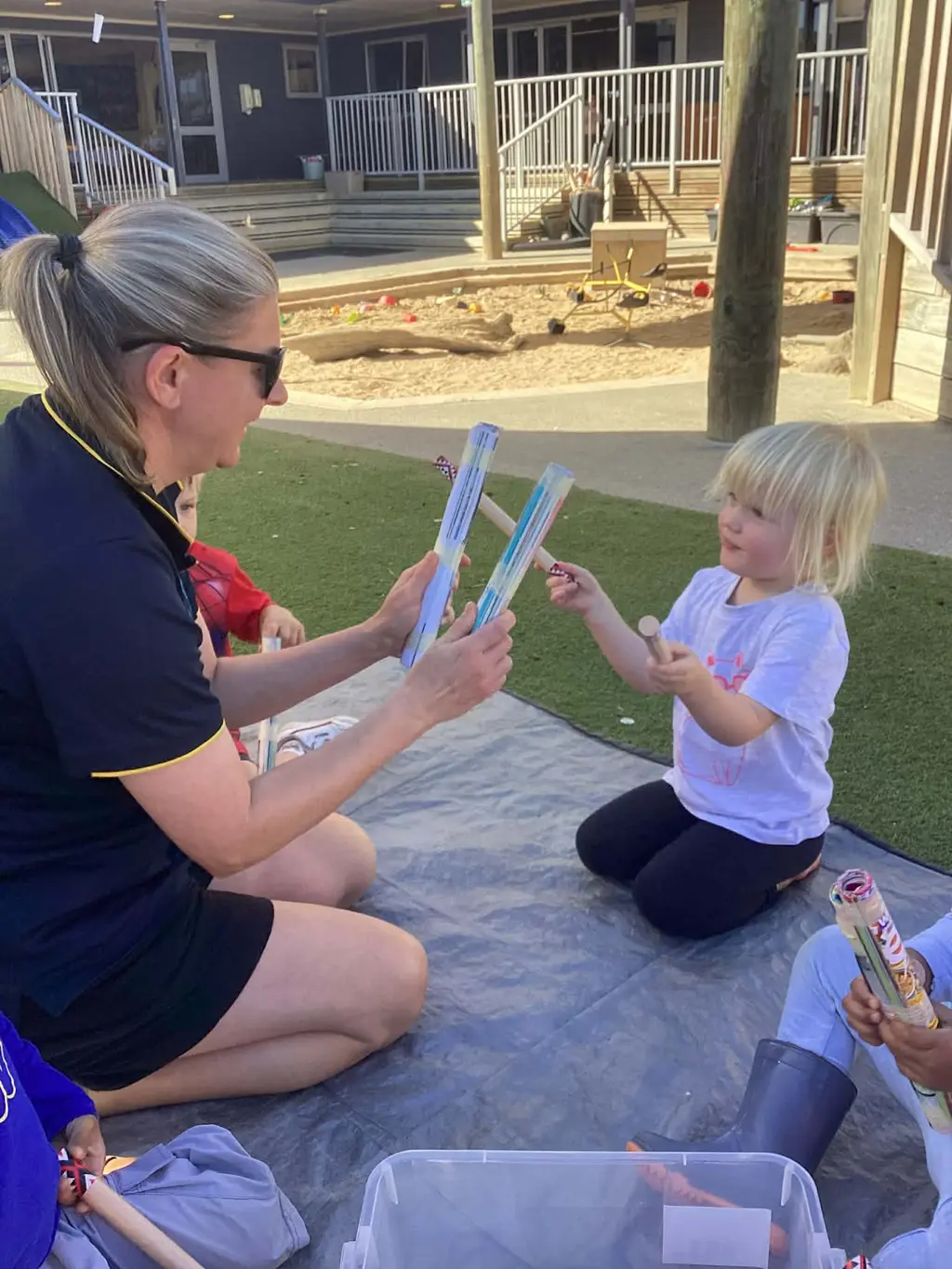 A kaiako sharing a playful learning moment with tamariki