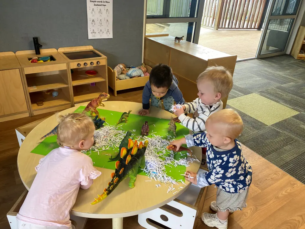 Toddlers exploring a dinosaur play experience